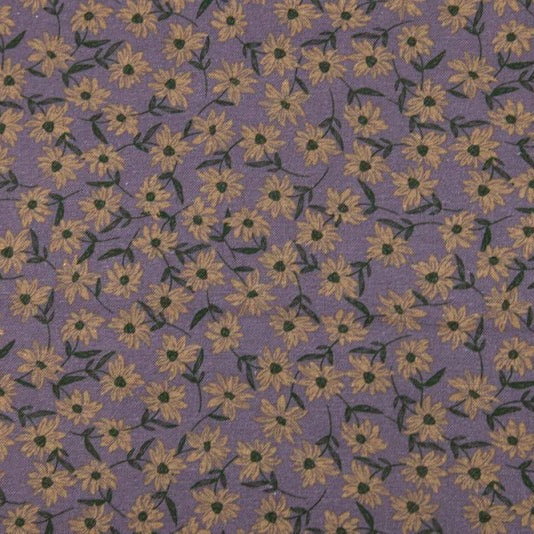 A close-up of a purple fabric with a repeating pattern of small yellow flowers and dark green leaves.