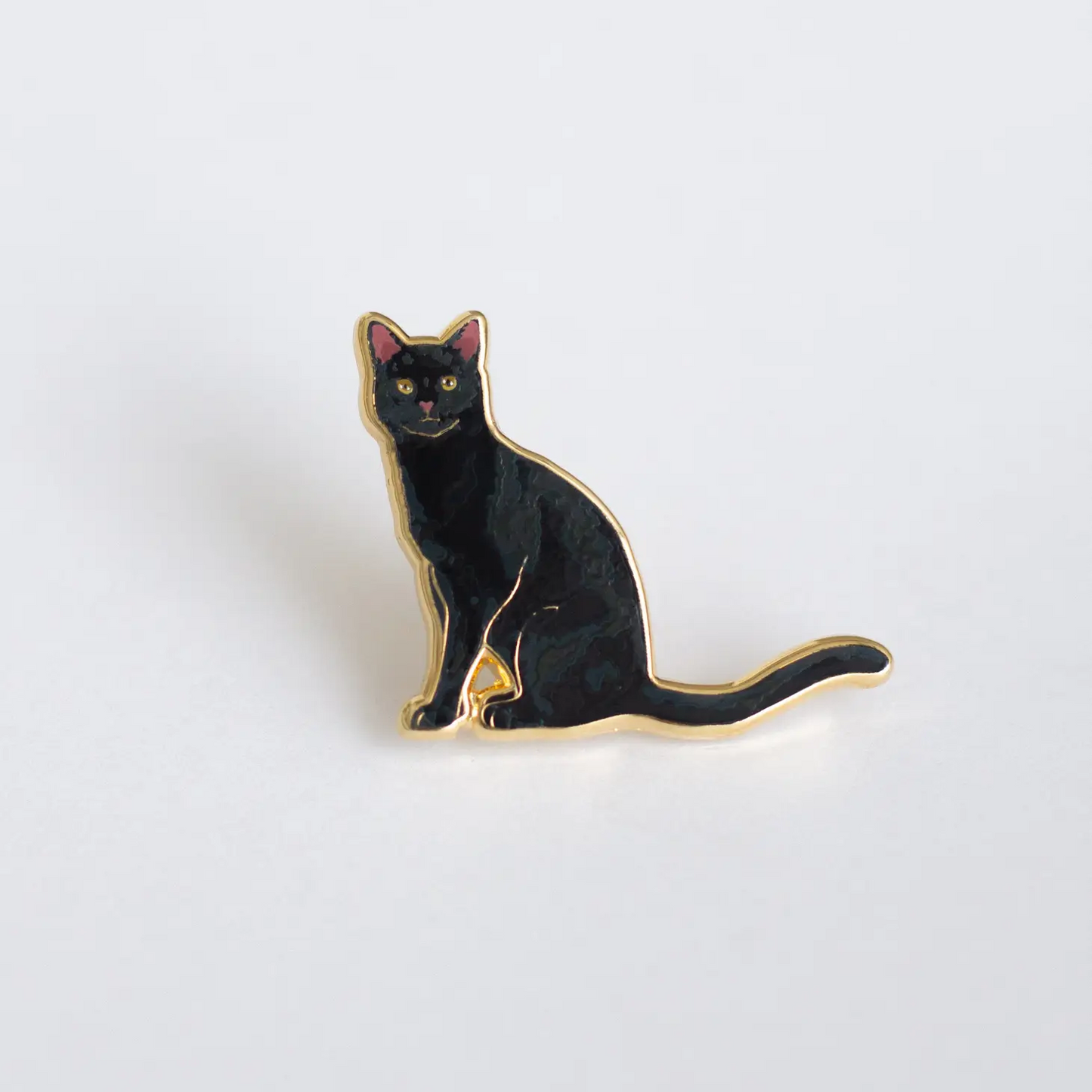 Black Cat Pin made of enamel with a gold outline. 