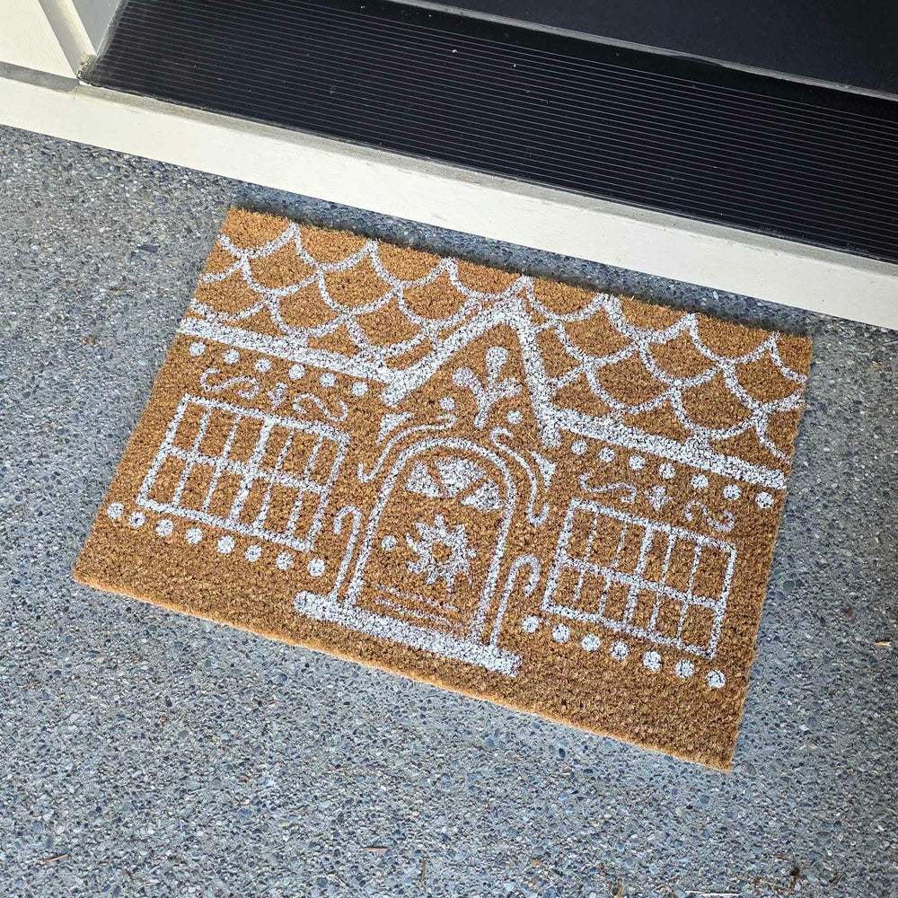 Picture of a rug painted to look like a gingerbread house