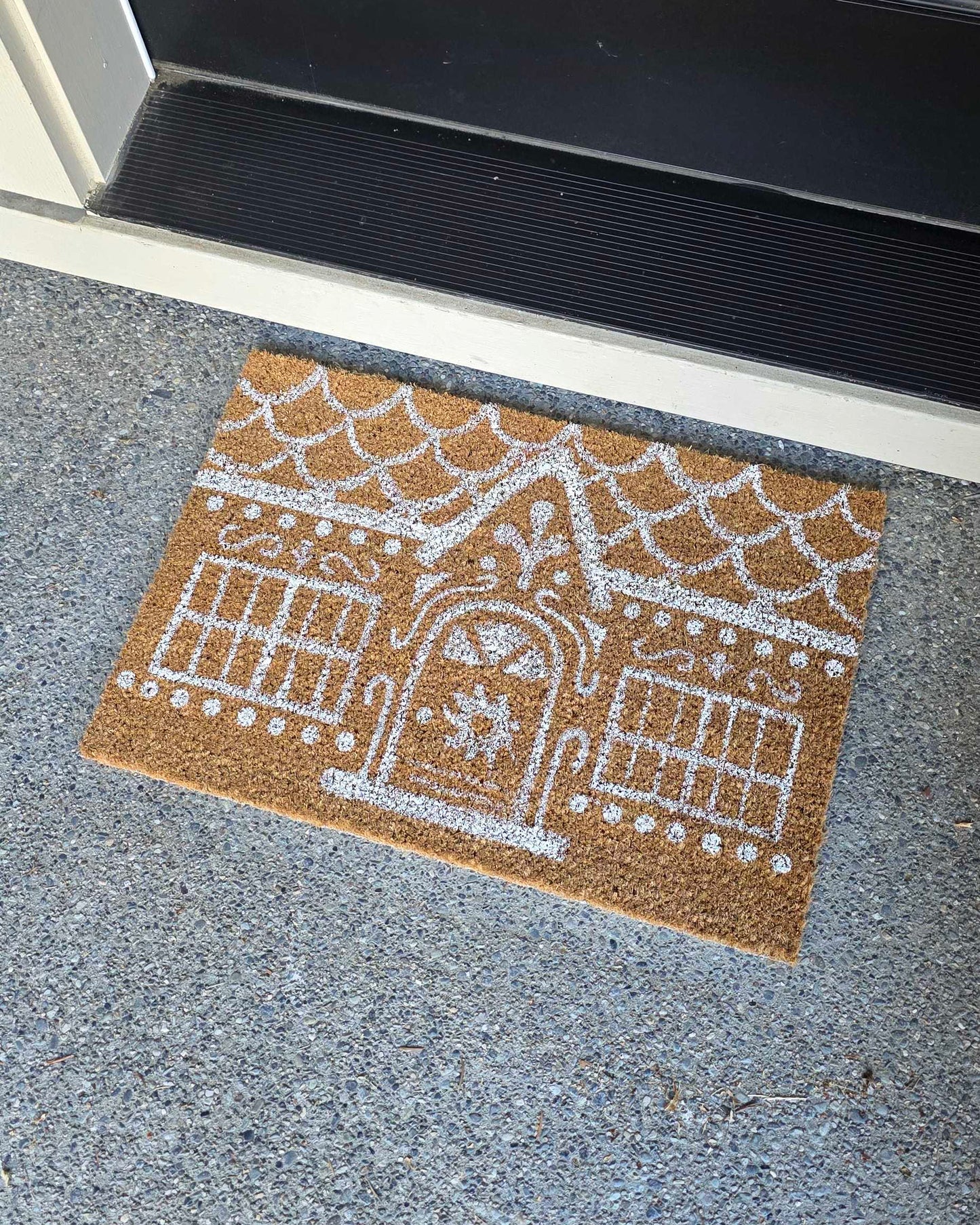 Picture of a rug painted to look like a gingerbread house