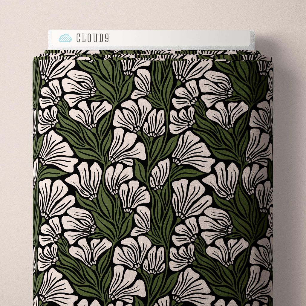 a bolt of fabric featuring sketched, trumpet-shaped blossoms and layered leaves arranged across a black background with cream and olive green accents against a white background