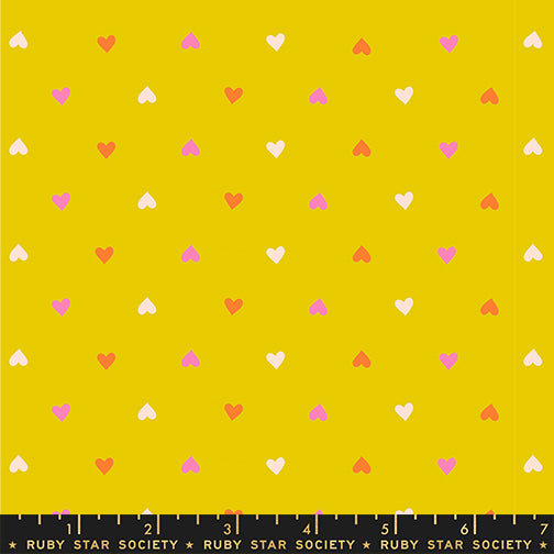 Pattern of small hearts on a yellow background with a ruler at the bottom.