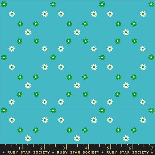 Floral pattern with white flowers and green leaves on a blue background, Ruby Star Society label at the bottom.