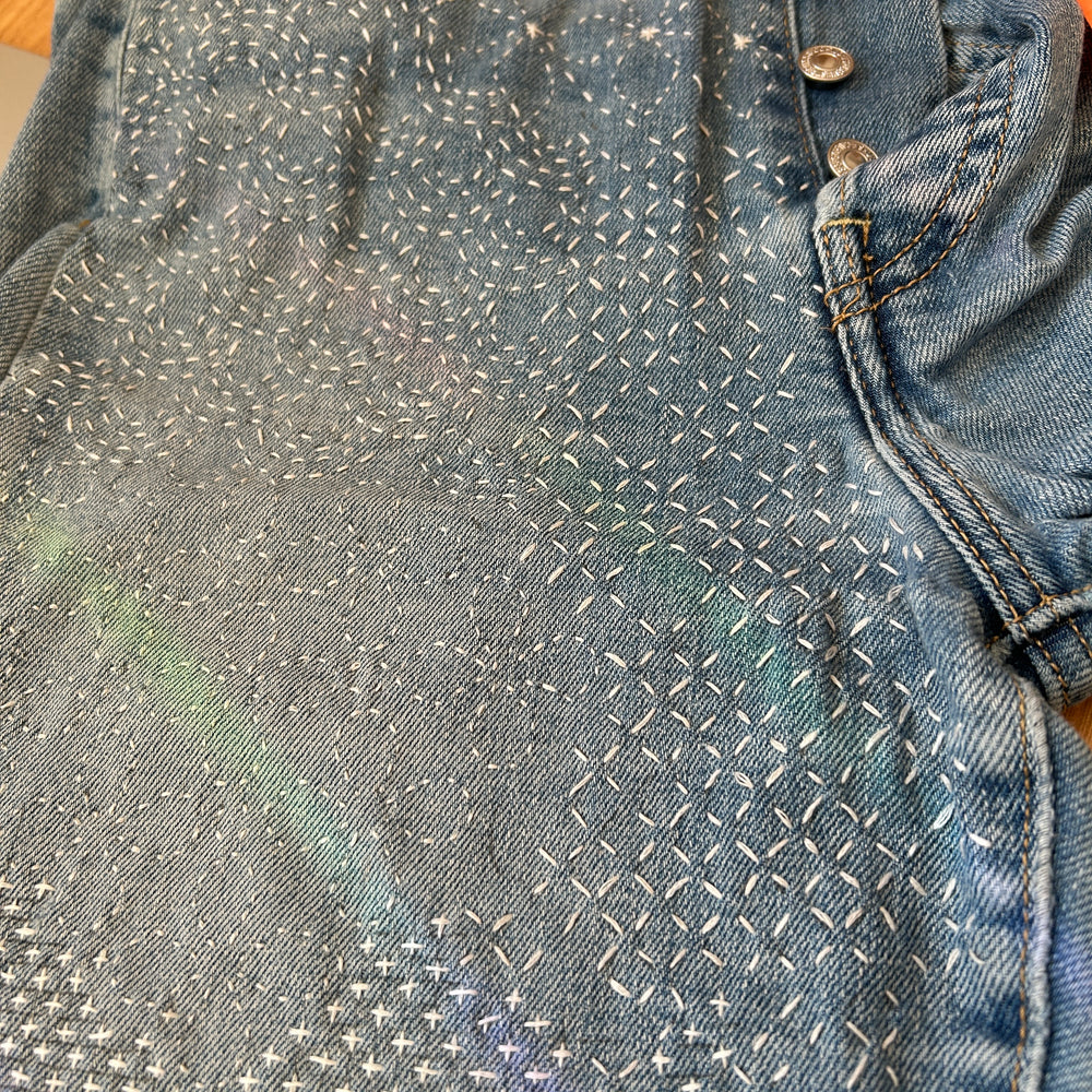 Jeans mended with sashiko style stitching