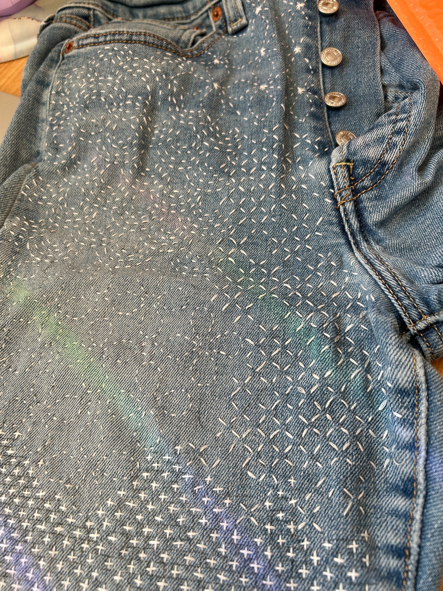 Jeans mended with sashiko style stitching