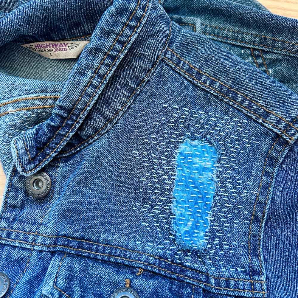 front of a jean jacket with sashiko style mending