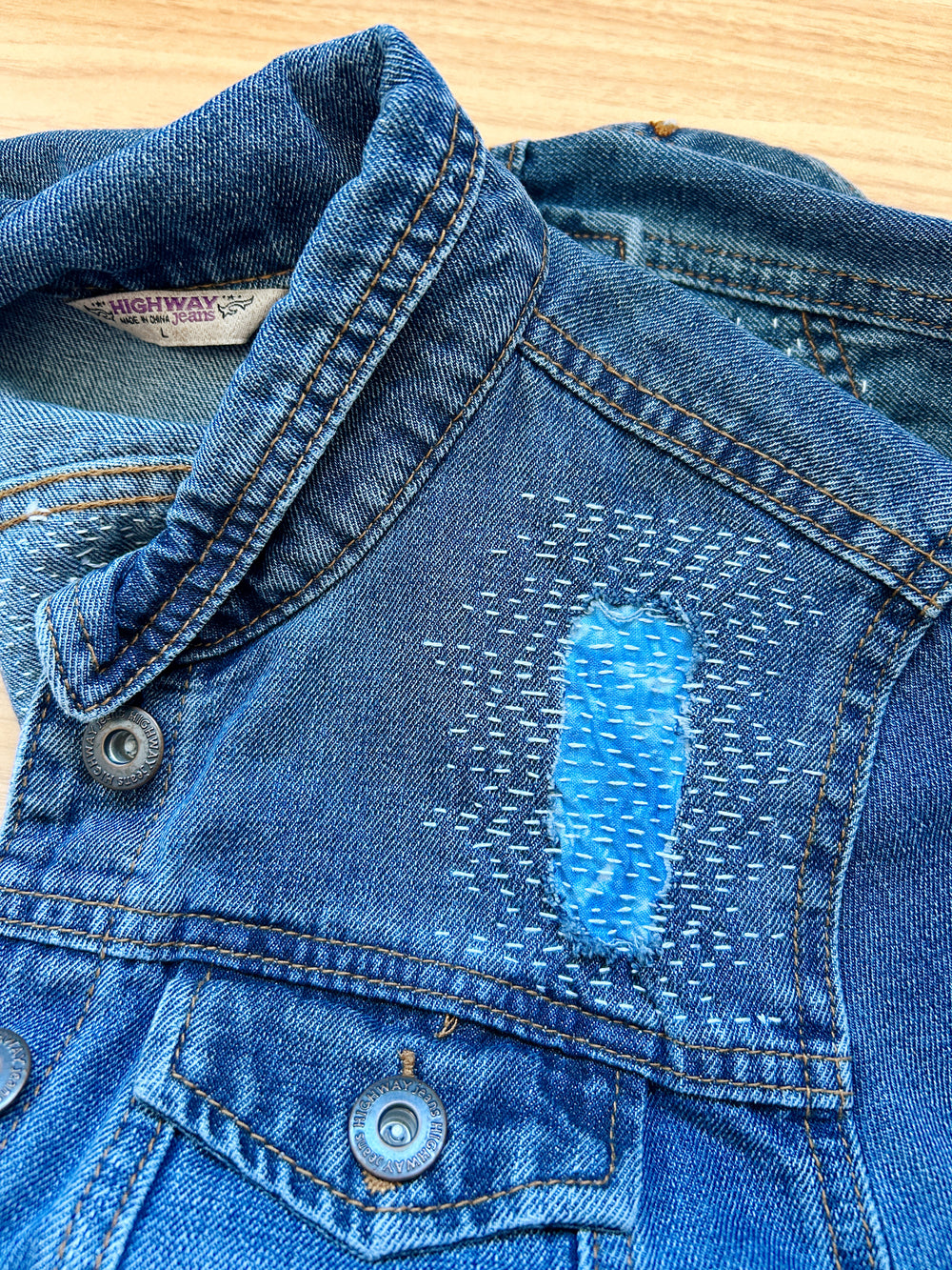 front of a jean jacket with sashiko style mending