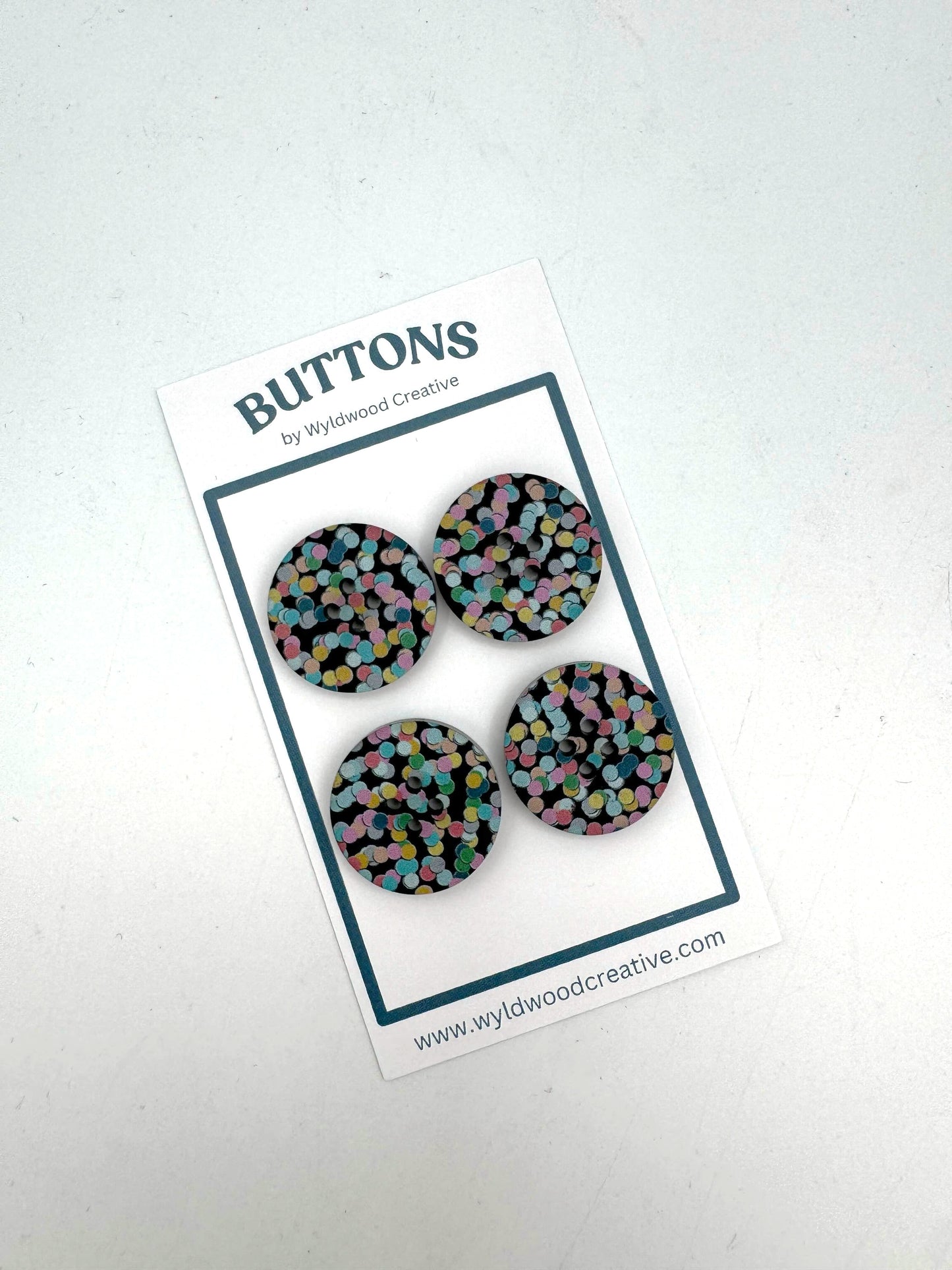 A set of  buttons on paper packaging against a white background