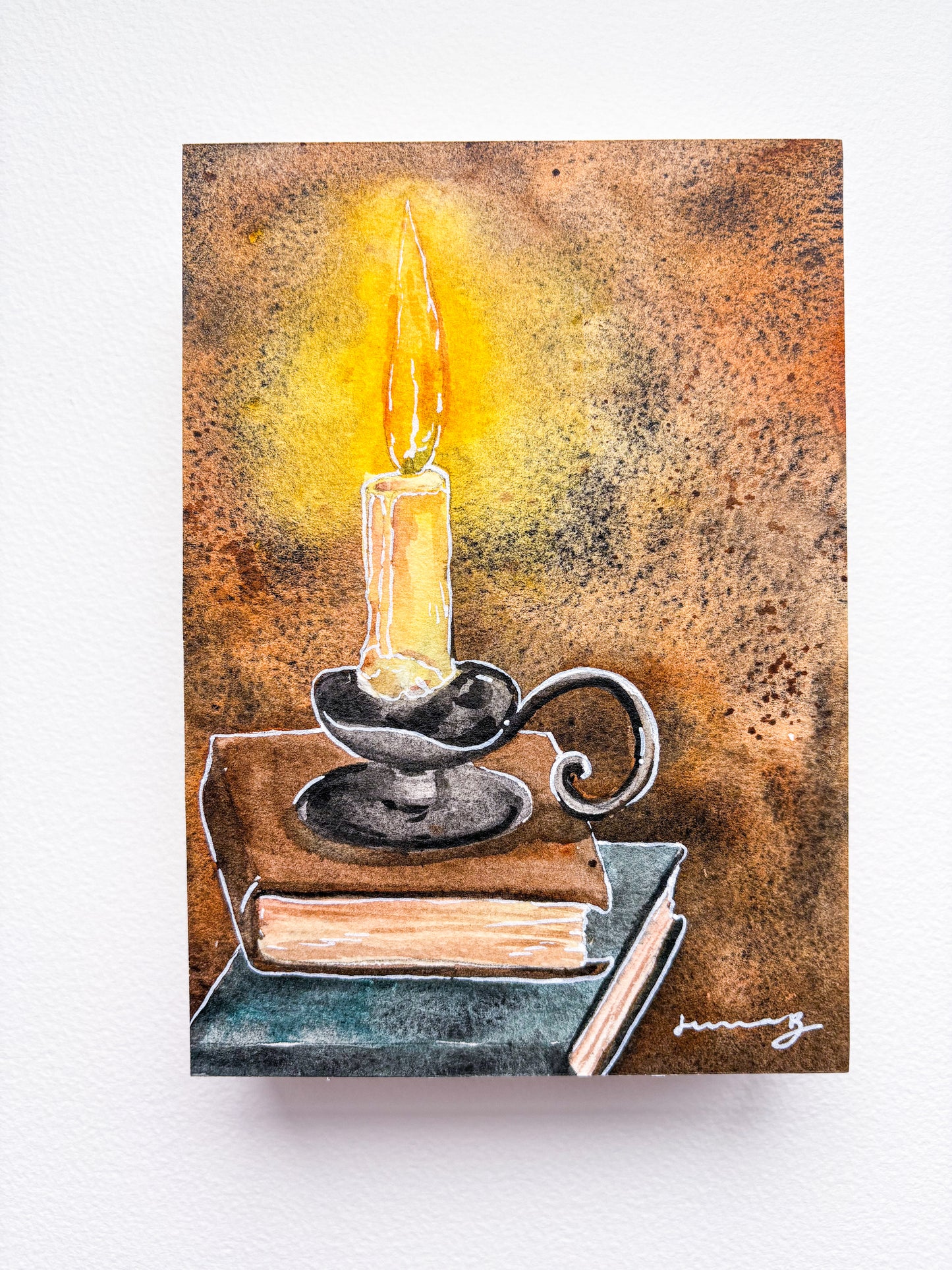 Water color books illuminated by candle light