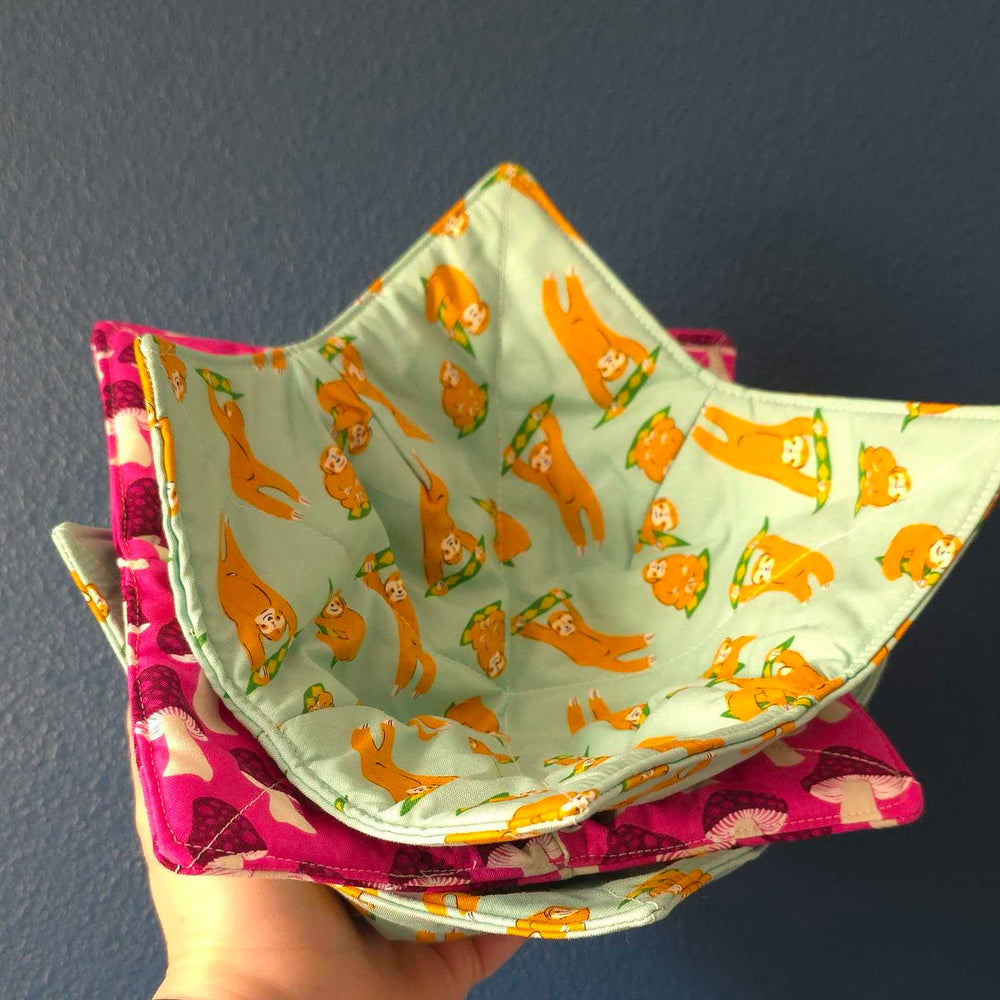 a stack of bowl cozies made from different fabric prints