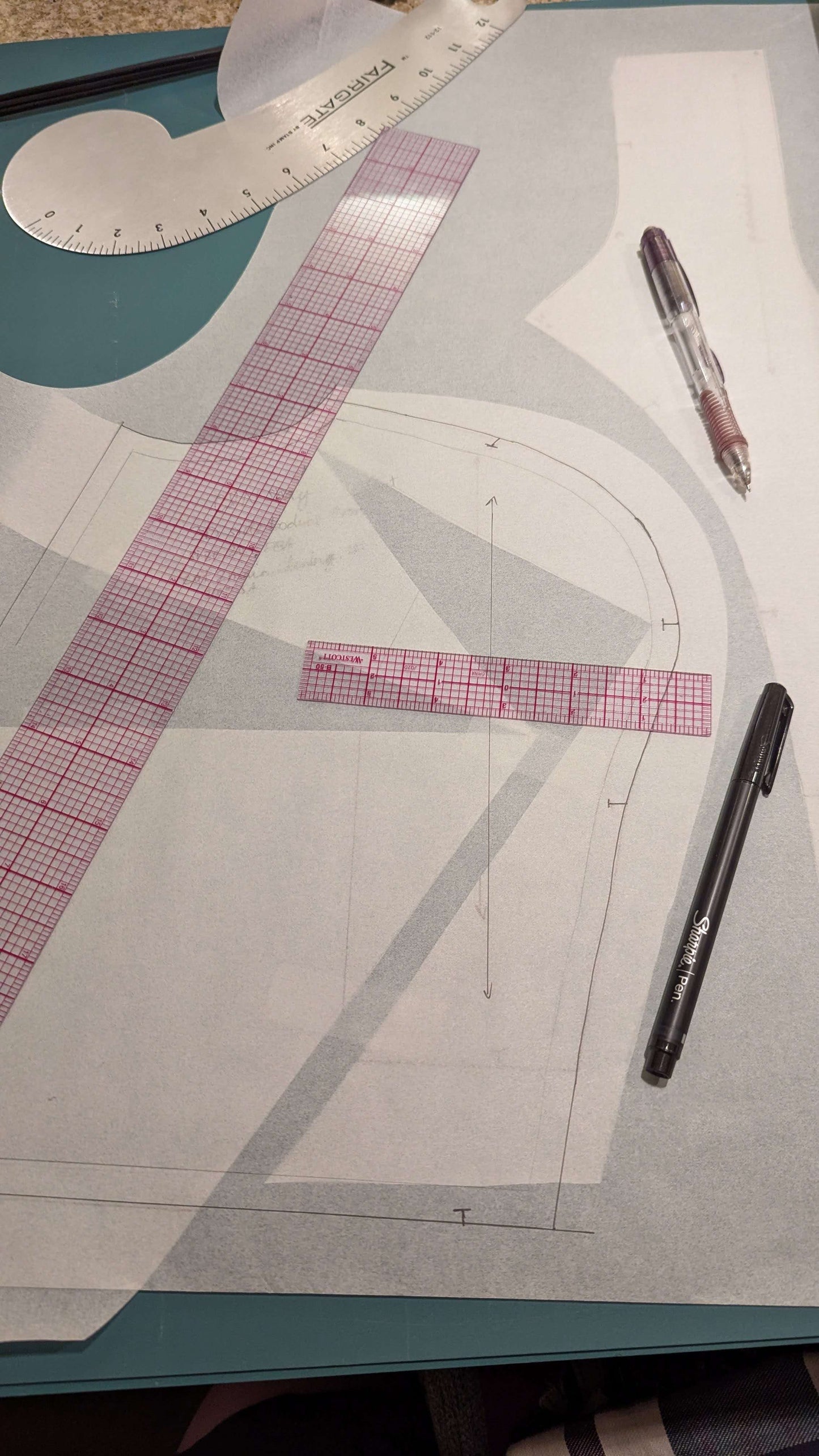 paper pattern pieces sitting on a table waiting to be adjusted 