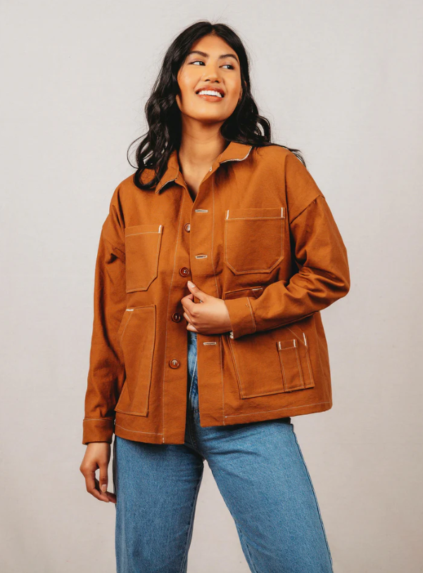 
                      
                        Model wearing a deep orange Ilford Jacket made in a sewing class at Wyldwood Creative in Renton
                      
                    