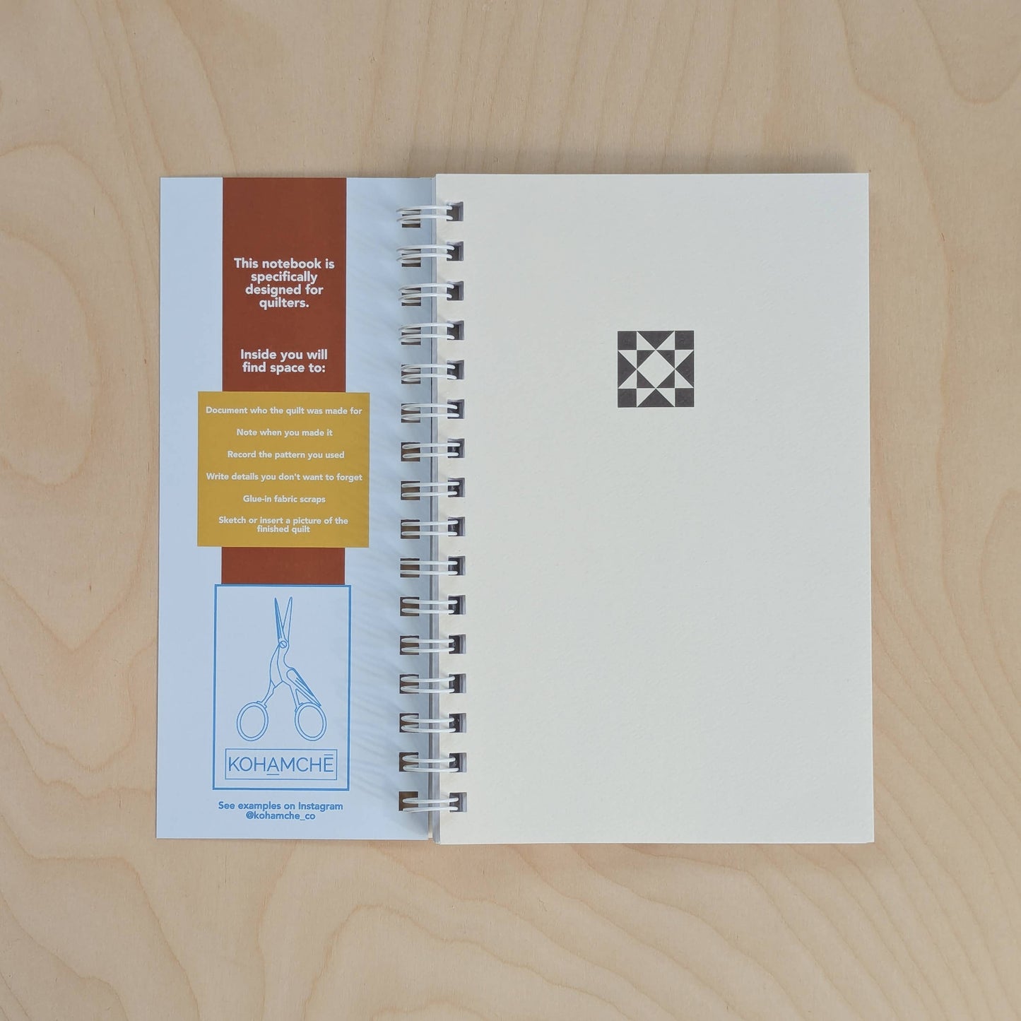 quilt Notebook with spiral binding on a wooden surface