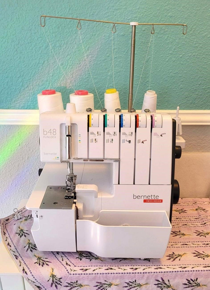 Serger with thread sitting at a table at a workspace during a serger class at Wyldwood Creative in Renton