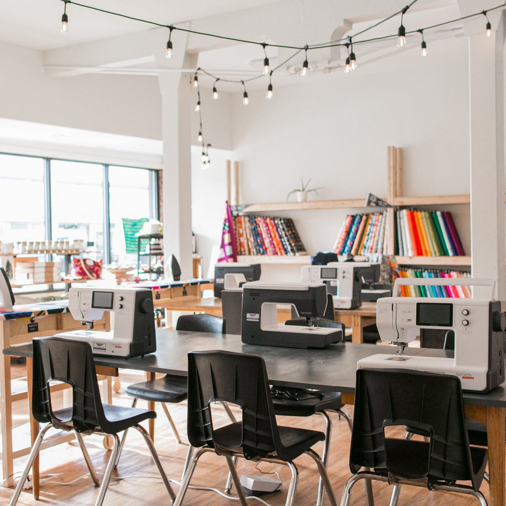 Private Sewing Lessons space with sewing machines and fabrics and irons at Wyldwood Creative in Renton