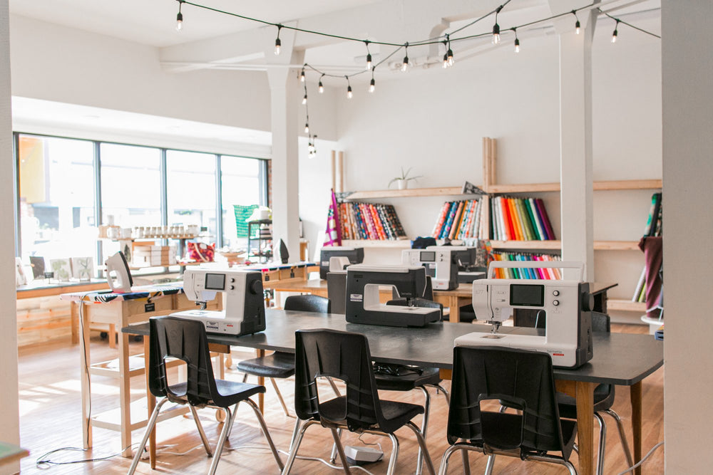 Private Sewing Lessons space with sewing machines and fabrics and irons at Wyldwood Creative in Renton